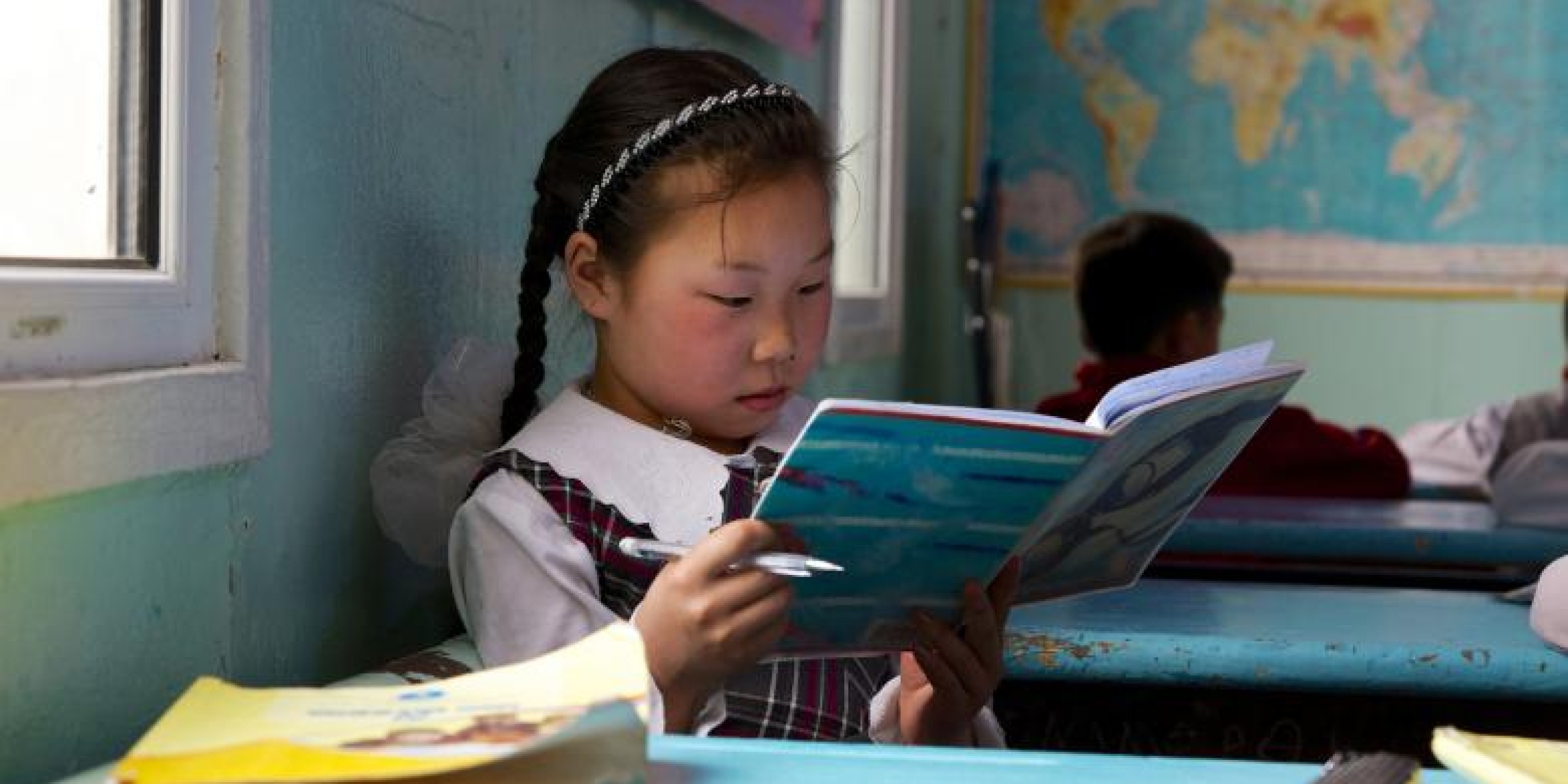 A girl reading a book in her classroom in Mongolia. Credit: Khasar Sandag/World Bank